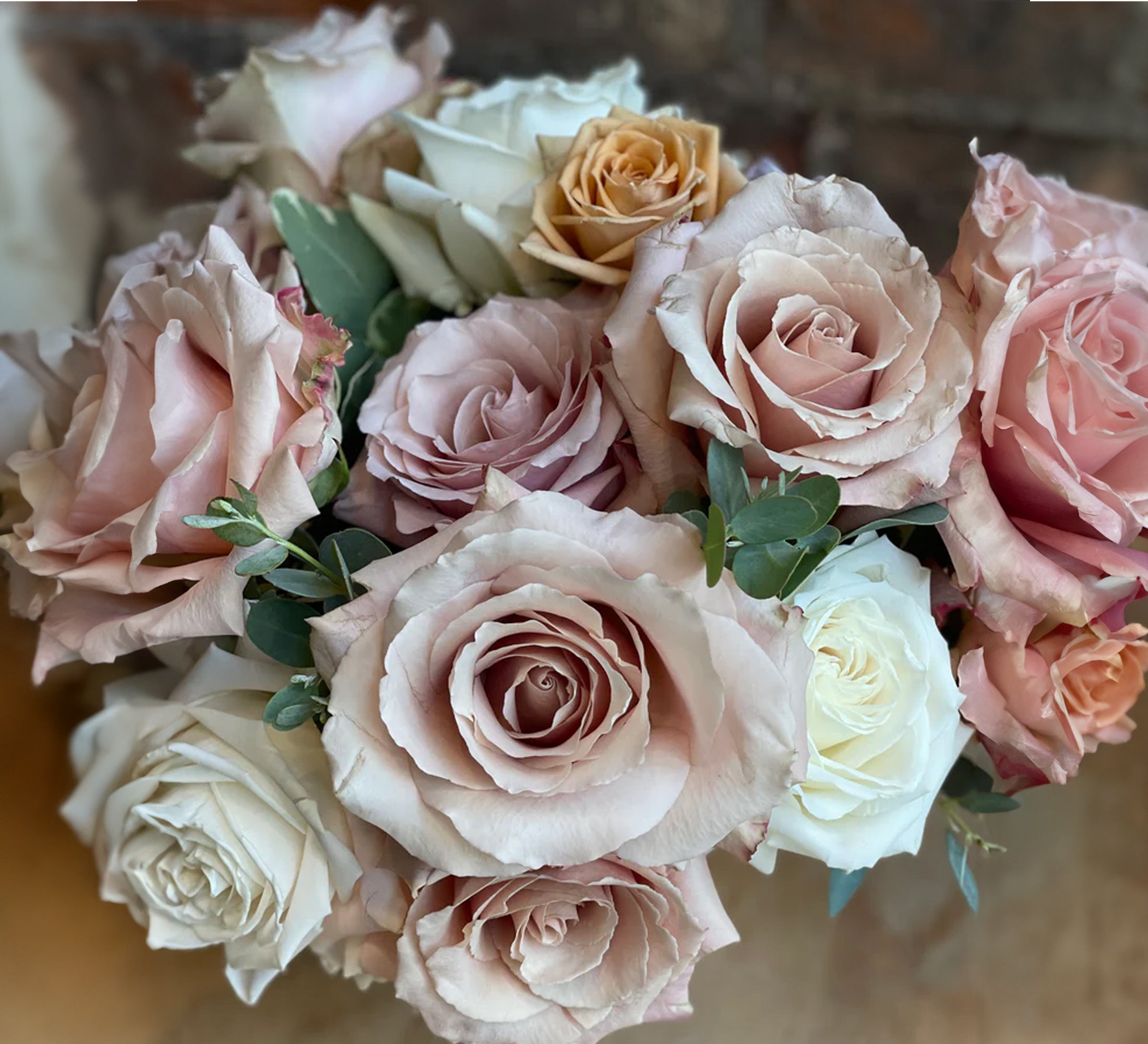 Pastel rose arrangement in a compote