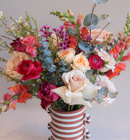 Fresh flower arrangement in a striped vase