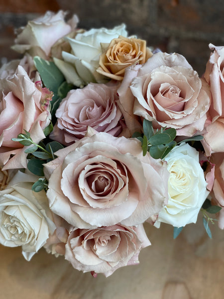 Pastel rose arrangement in a compote