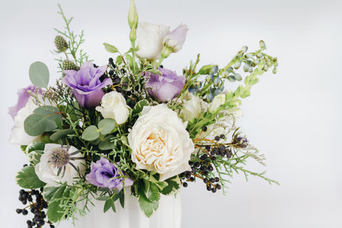 Fresh flower arrangement in cool tones (4" white vase)