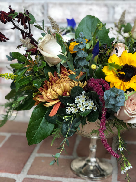 Large compote arrangement in fall tones